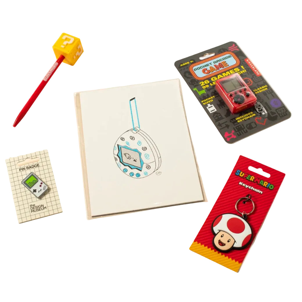 A flat-lay collection of gaming-themed stationery and accessories on a light beige background