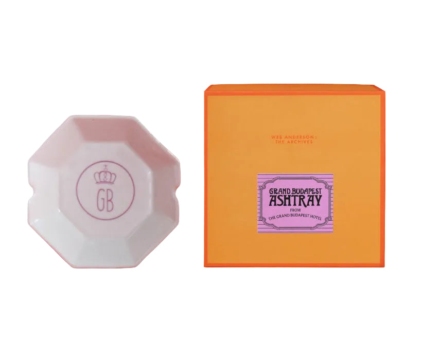 Pink ashtray and orange box with purple label on a red background