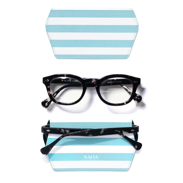 Black tortoiseshell round-frame eyeglasses shown with a matching light blue and white striped case, with a second case view above and the glasses resting on the lower case below. 