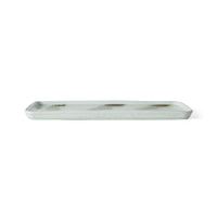 Light green rectangular ceramic tray with wavy brown pattern on a white background.