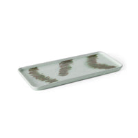 Light green rectangular ceramic tray with wavy brown pattern on a white background.