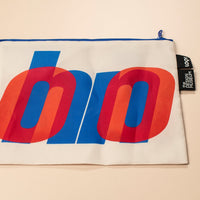 Pouch with colorful logo and brand tag on a beige background