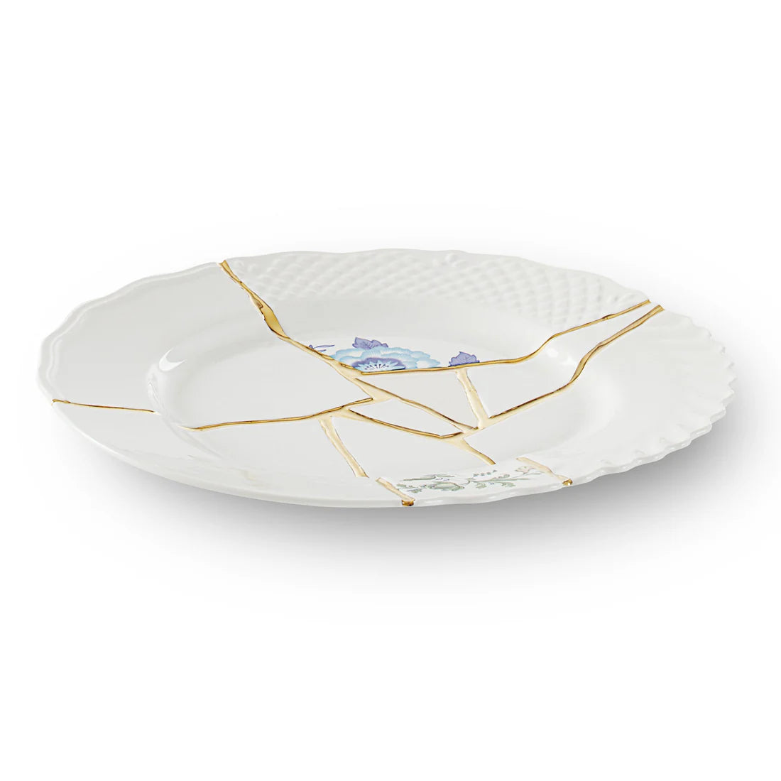 Decorative plate with gold kintsugi accents and floral design on a white background