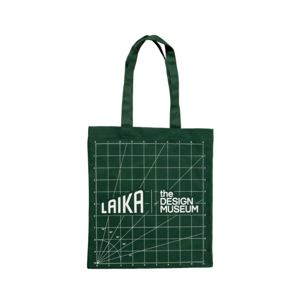 A dark green canvas tote bag with matching green fabric handles, featuring a white printed design of a drafting grid, measurement lines, and the text 'the DESIGN MUSEUM LAIKA'. 