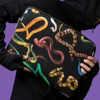 Black laptop bag with colourful snake designs held by a person against a purple background