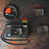 Vintage camera with lens attachments on a textured surface