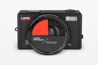 Camera lens with red and black split filter on a white background