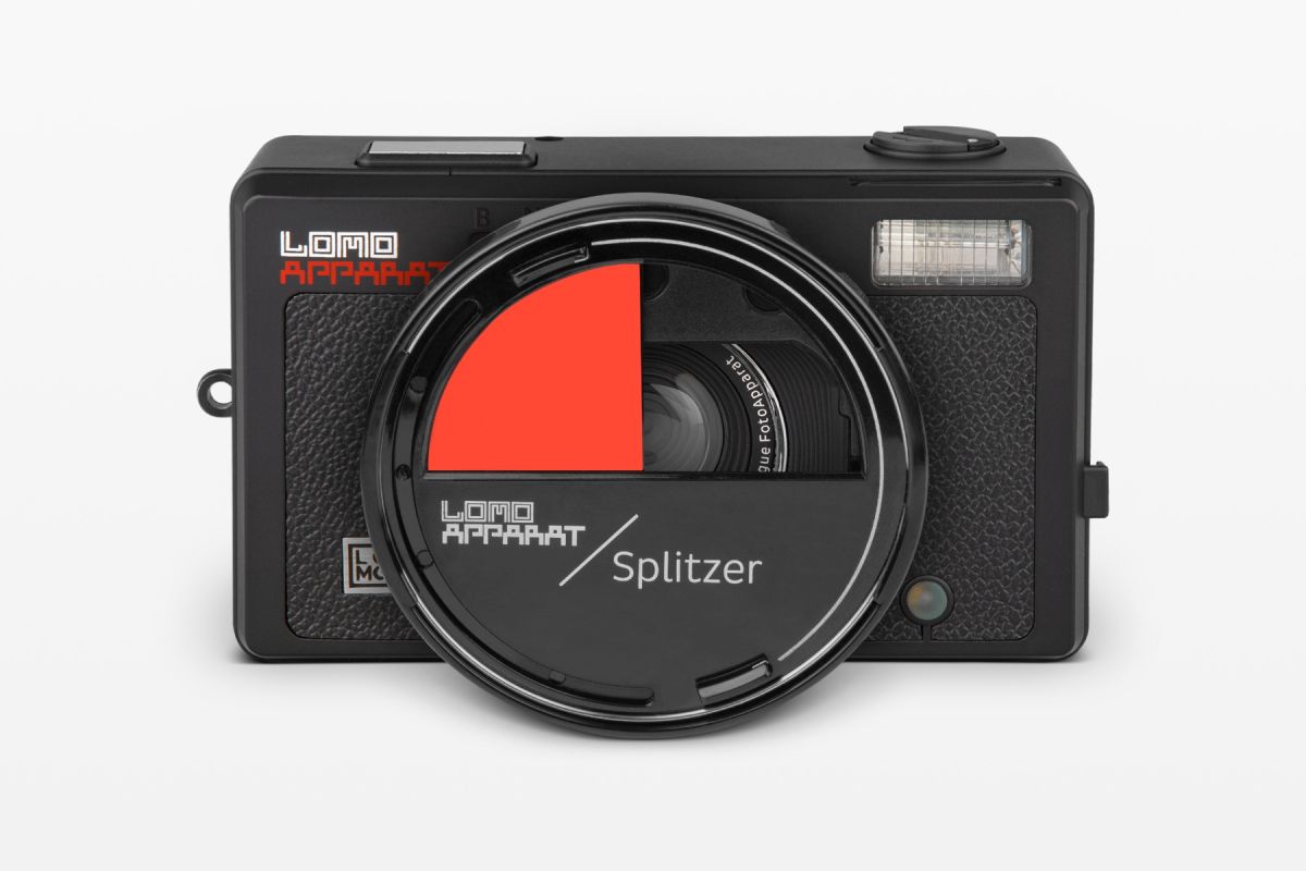 Camera lens with red and black split filter on a white background