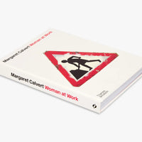 Book titled 'Woman at Work' by Margaret Calvert with a warning sign design on the cover.