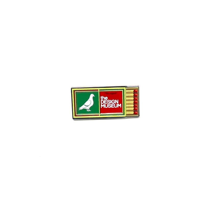 green and yellow matchbox pin badge with 'The Design Museum' logo on a white background