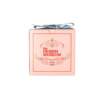 Pink Mendl's teabags box with a blue ribbon and 'The Design Museum' branding on a white background