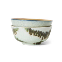 Two green and blue abstract ceramic bowls stacked on a white background.