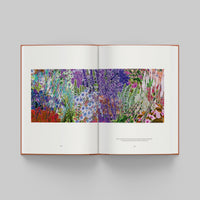 Open page of More Than Human catalogue featuring a colorful illustration of flowers on a gray background