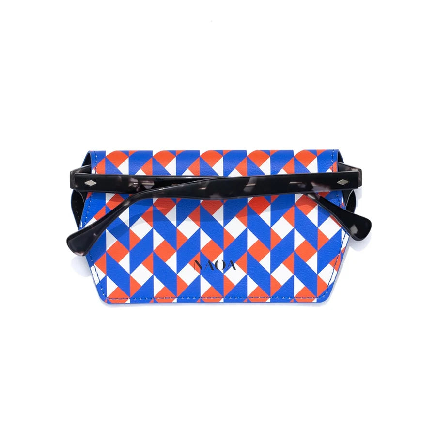 A glasses case with a blue, orange, and white geometric triangle pattern with black glasses inside on a white background.