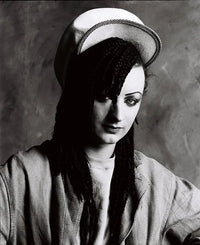 Black and white portrait of a person wearing a sailor hat and uniform.