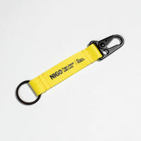 Yellow keychain with a carabiner on a white background