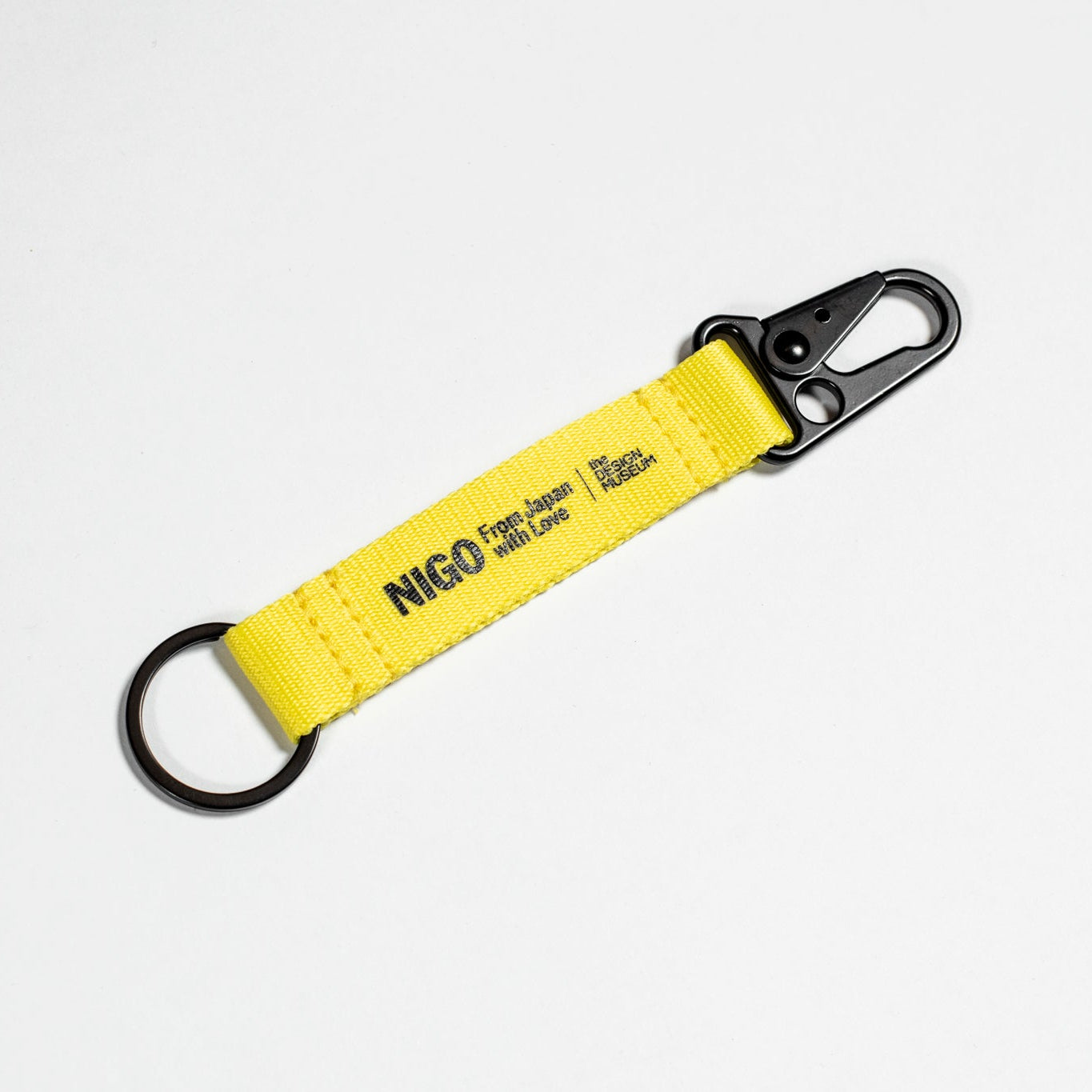 Yellow keychain with a carabiner on a white background