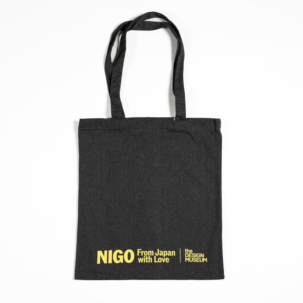 Black tote bag with yellow text on a white background