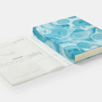 Nike Apparel book with dust jacket removed revealing a blue water-stained designed cover.