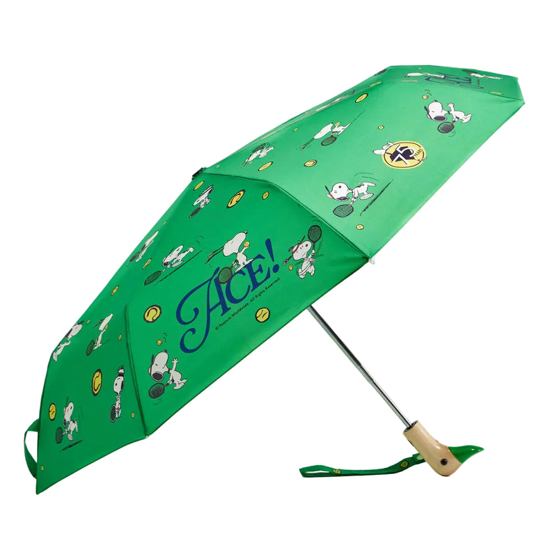 Green patterned umbrella open on a white background