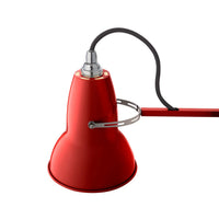 Red lamp with a black cord on a white background