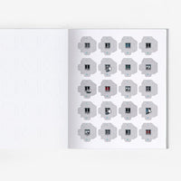 Open page of Panelki model featuring cut out pieces of brutalist building blocks.