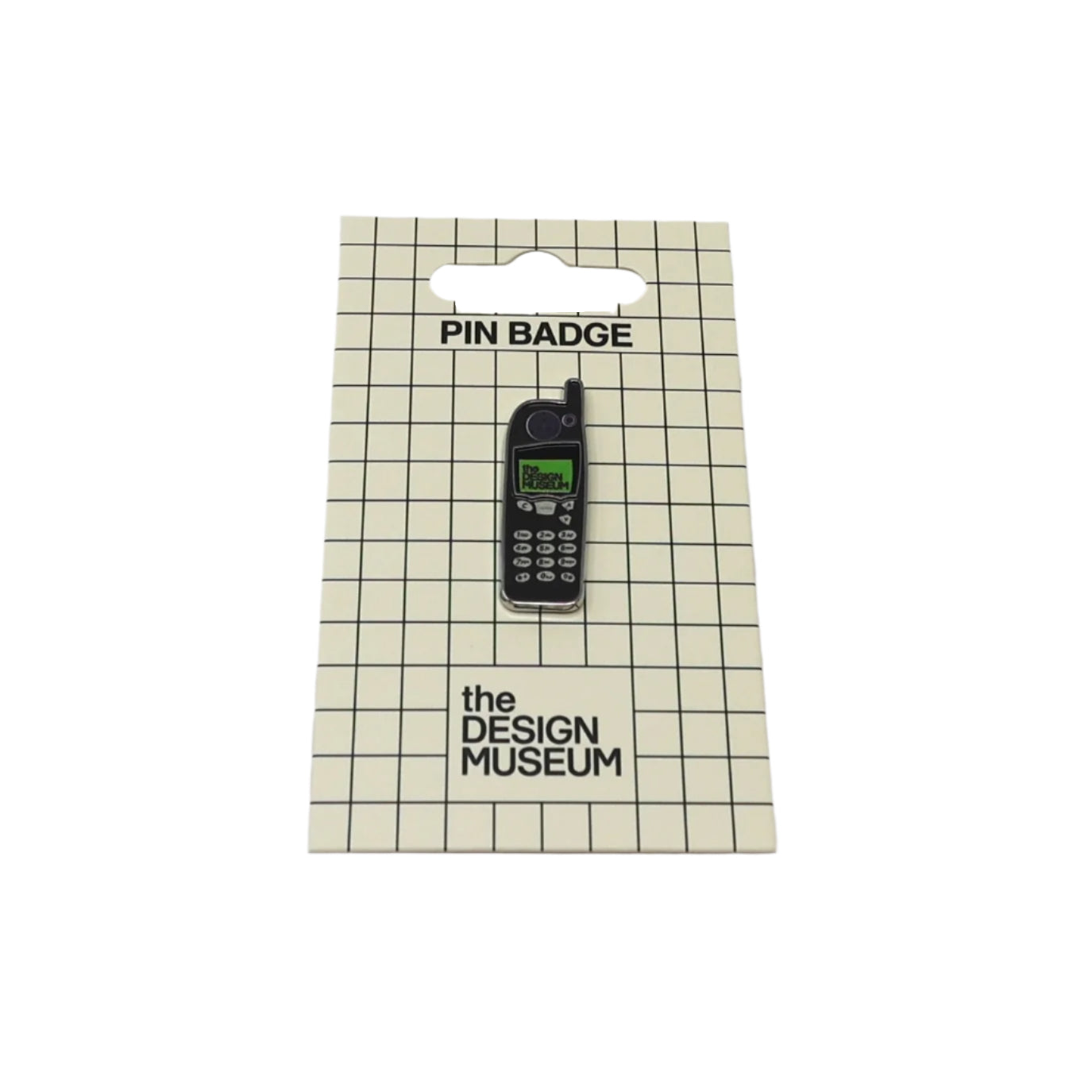 Pin badge of a vintage phone on packaging from The Design Museum
