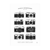 A black and white monochrome print with illustrations of various digital cameras on a white background. 