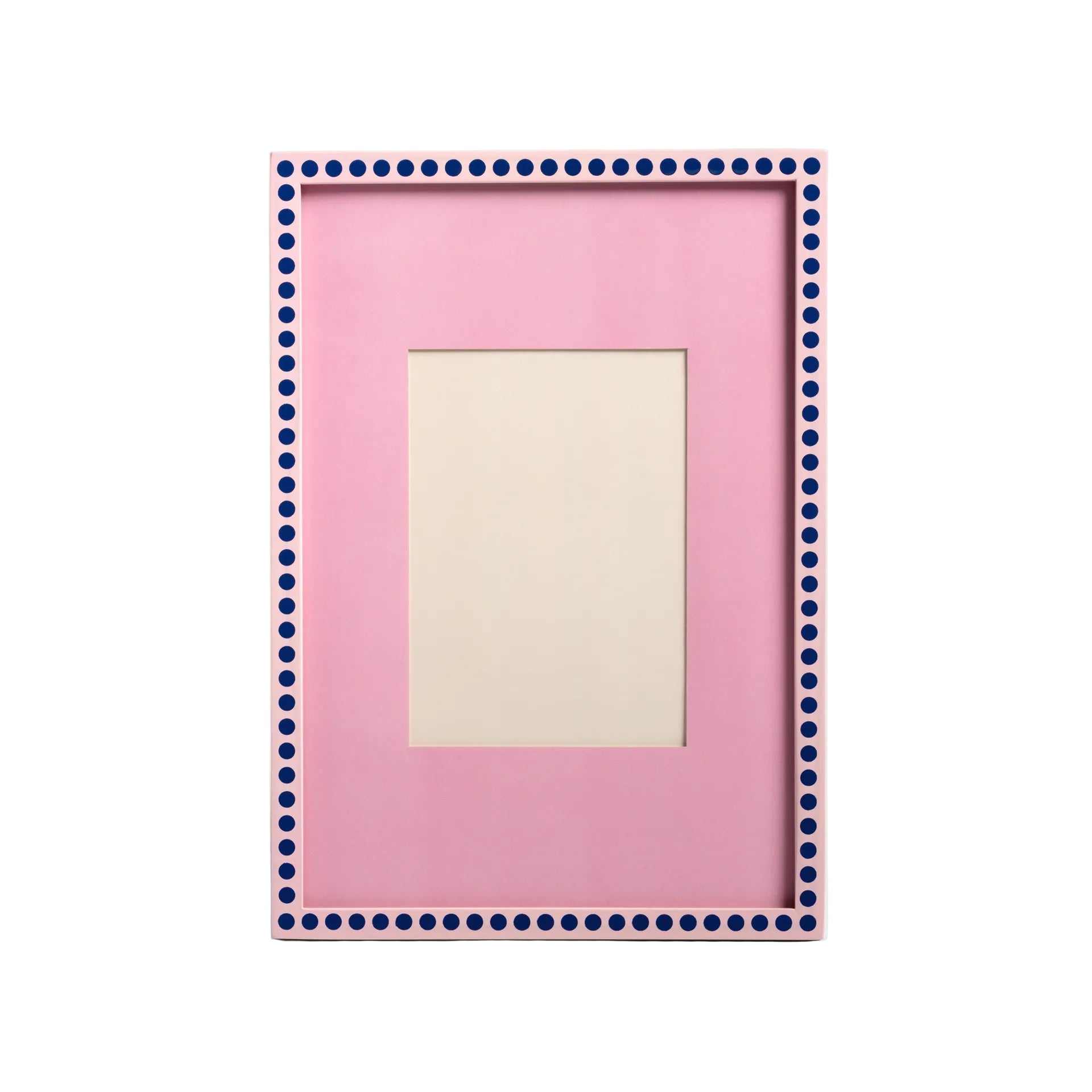 Pink picture frame with blue polka dot border on a light gray background