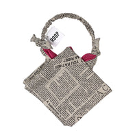 Handmade bag made from newspaper with 'ROOP' branding on a white background