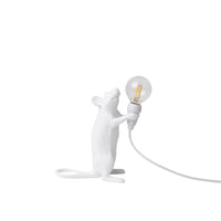 White mouse-shaped lamp holding a light bulb on a white background