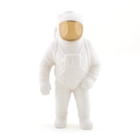 White astronaut vase with a gold visor on a white background