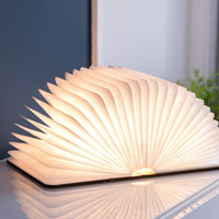 Book-shaped lamp on a desk with a blurred background