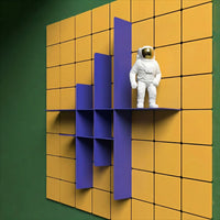 White astronaut vase on a blue shelf against a yellow and green tiled wall