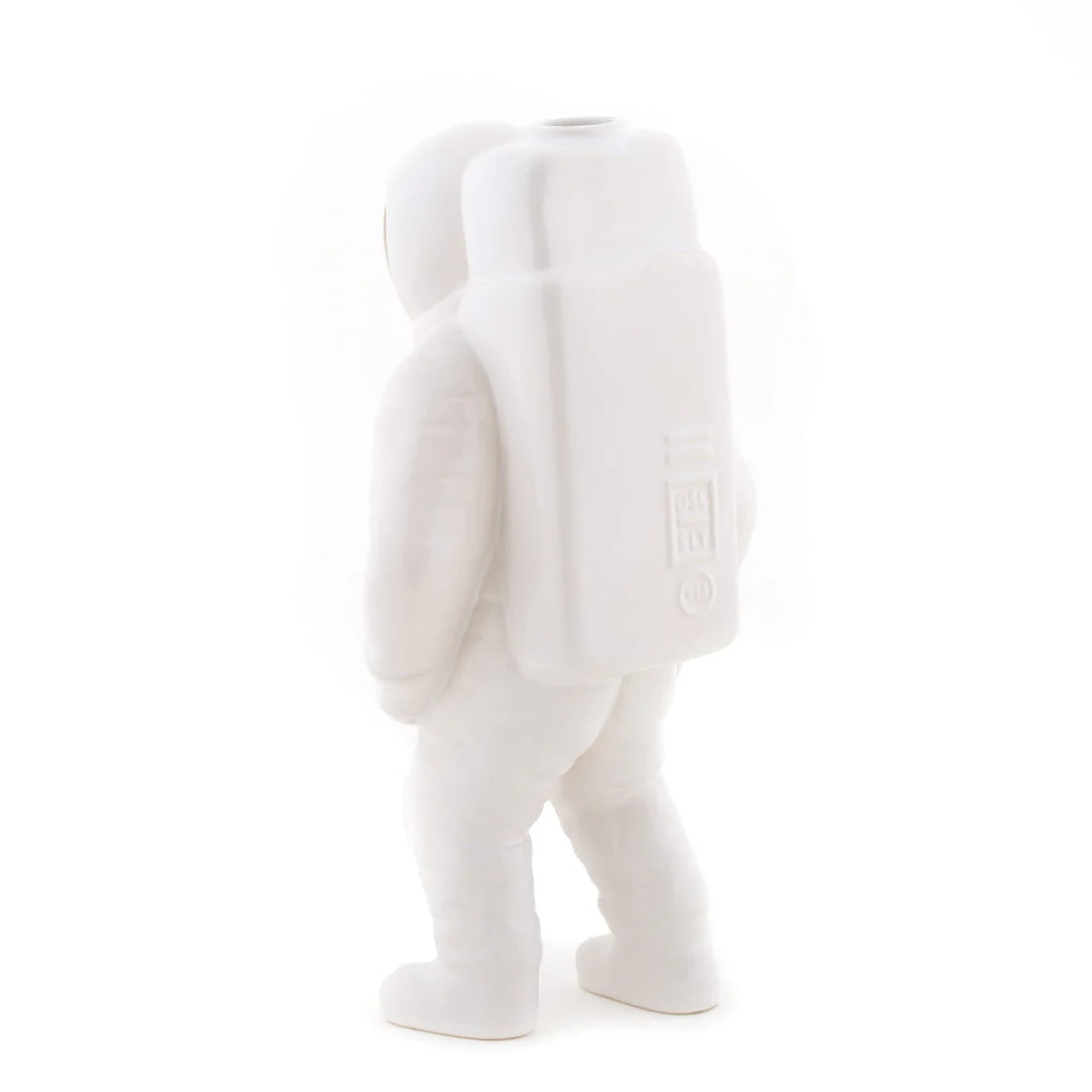 The back of a white ceramic astronaut vase on a white background