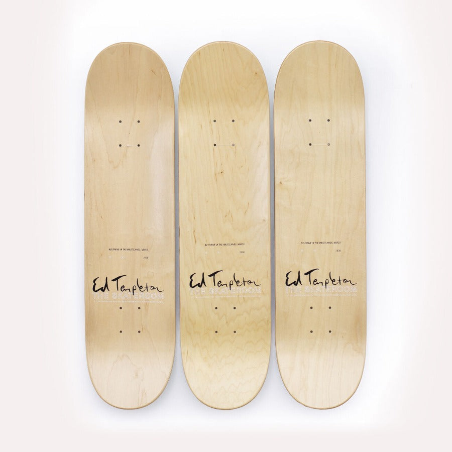 Three wooden skateboards next to each other