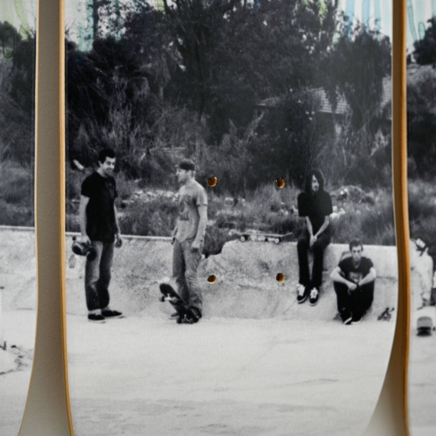 Closeup image of skateboard with black and white photograph printed on it