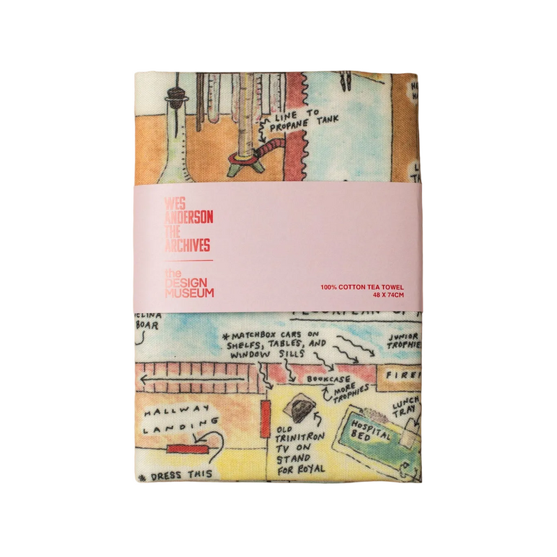 Colourful packaged tea towel with pink design museum branded sleeve on a white background