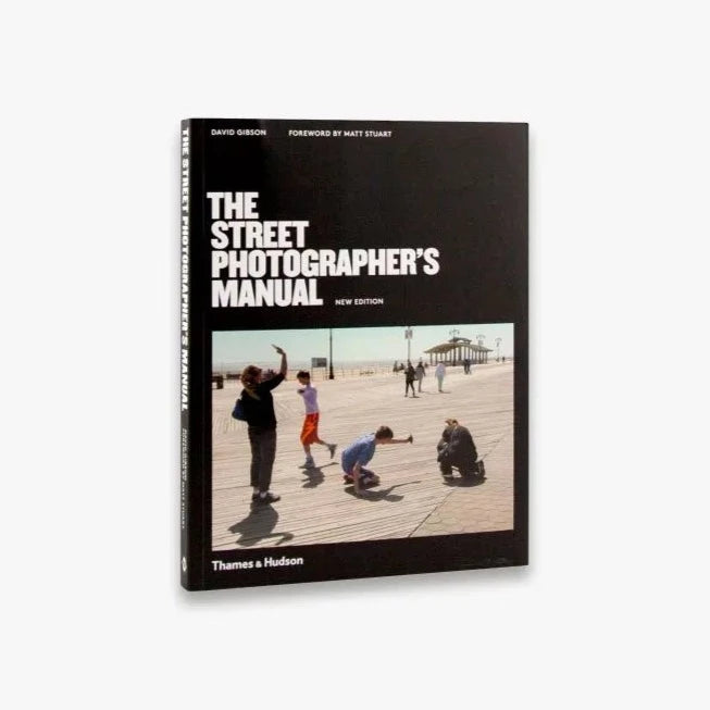 front cover of "The street photographer's manual book" b Thames & Hudson, book cover has a picture of kids taking pictures on what it looks like a sunny day in the pier by the seaside somewhere in the USA.