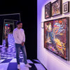 Picture at the Design Museum of a visitor looking at the Real Tim Burton Surrounded artwork that represents the print available for sale in different size.