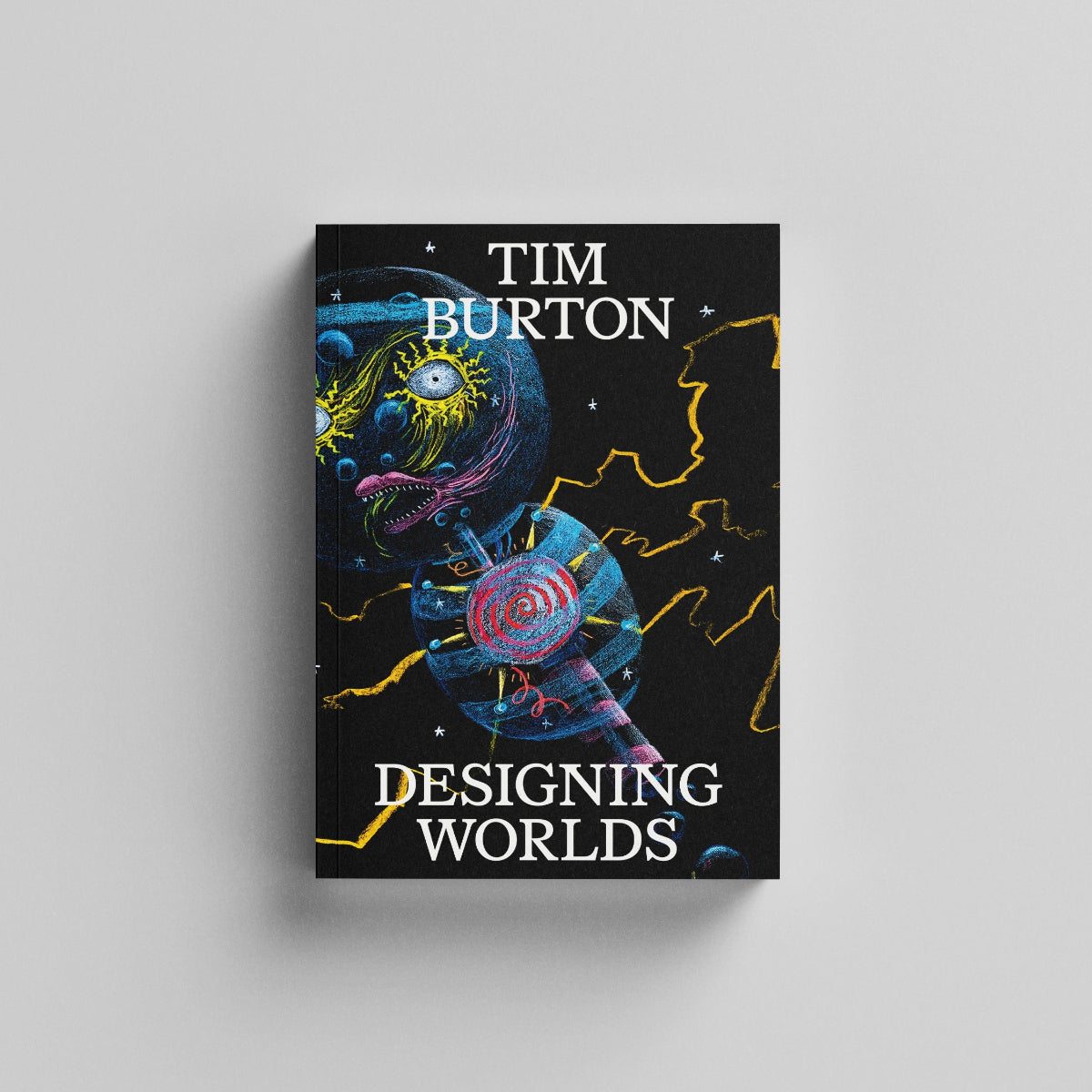 The front cover of 'Designing Worlds' catalogue by Tim Burton featuring a colourful absract illustration of an alien on a black background.