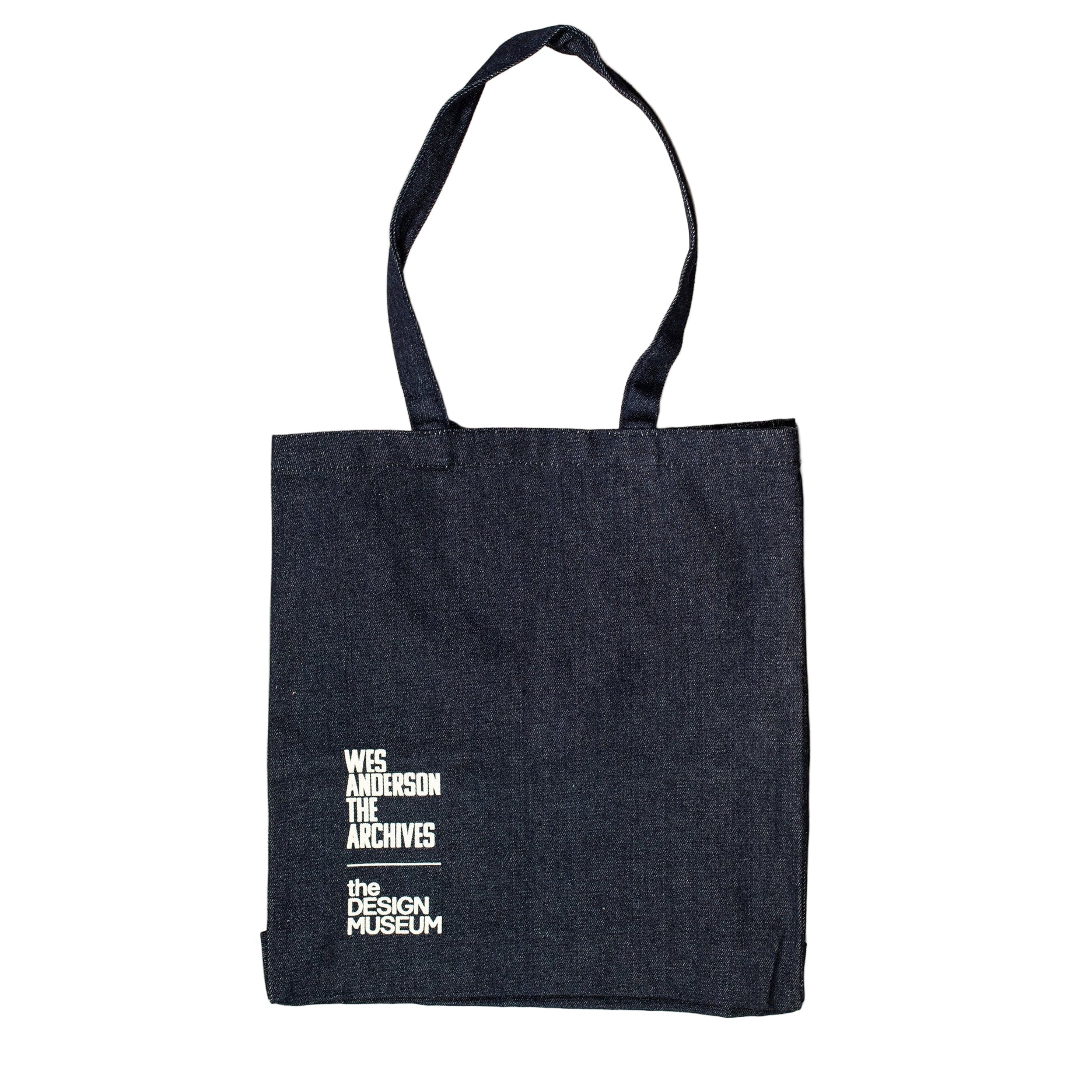 Black tote bag with white text on a beige background