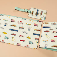 Set of white leather travel accessories with vintage vehicle illustrations on a beige background