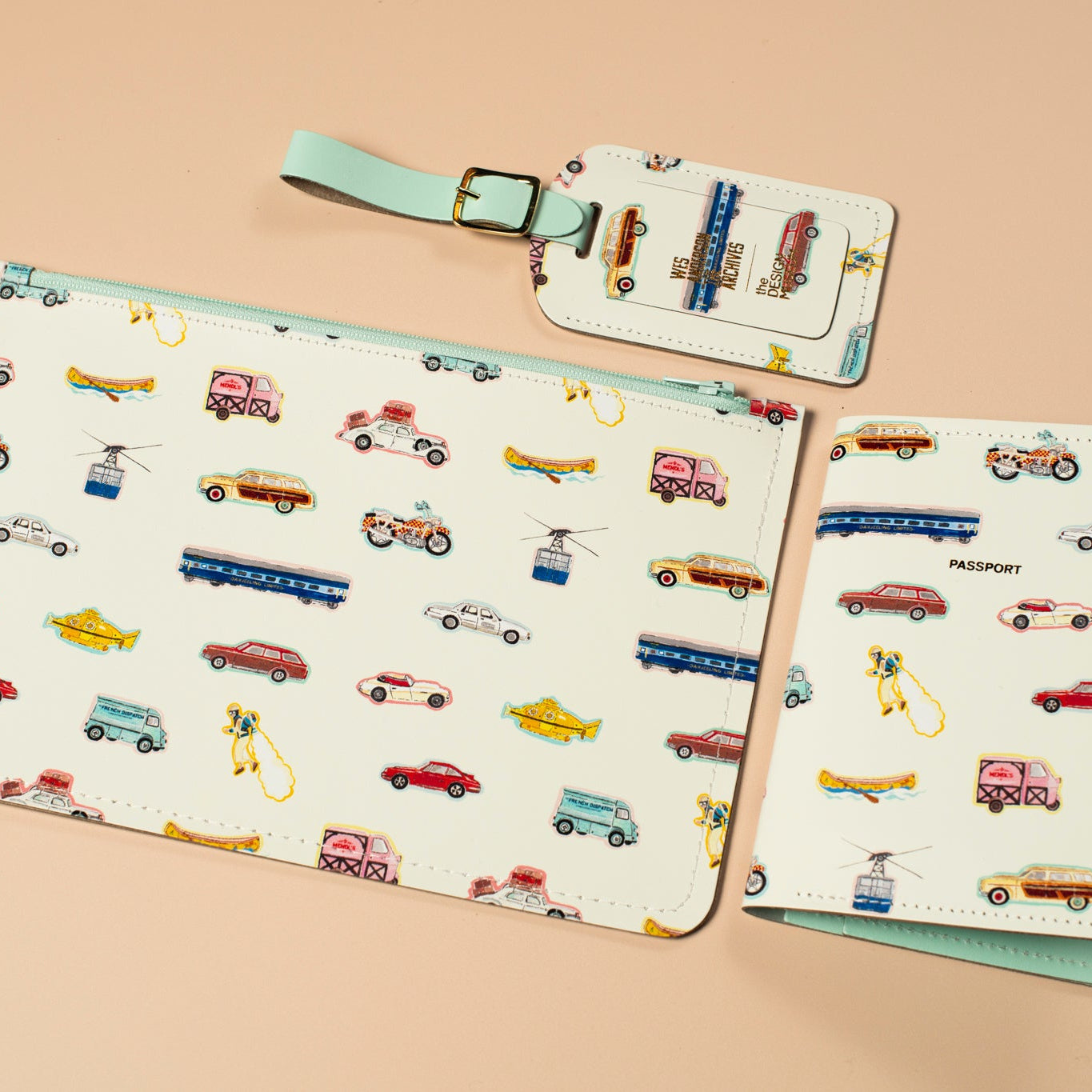 Set of white leather travel accessories with vintage vehicle illustrations on a beige background