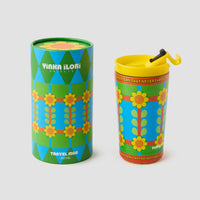 Colorful travel mug with retro floral pattern and matching packaging on a light gray background