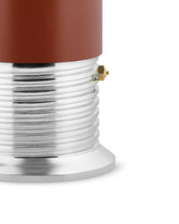 Close-up of a coffee pot with a brown top and silver base on a white background