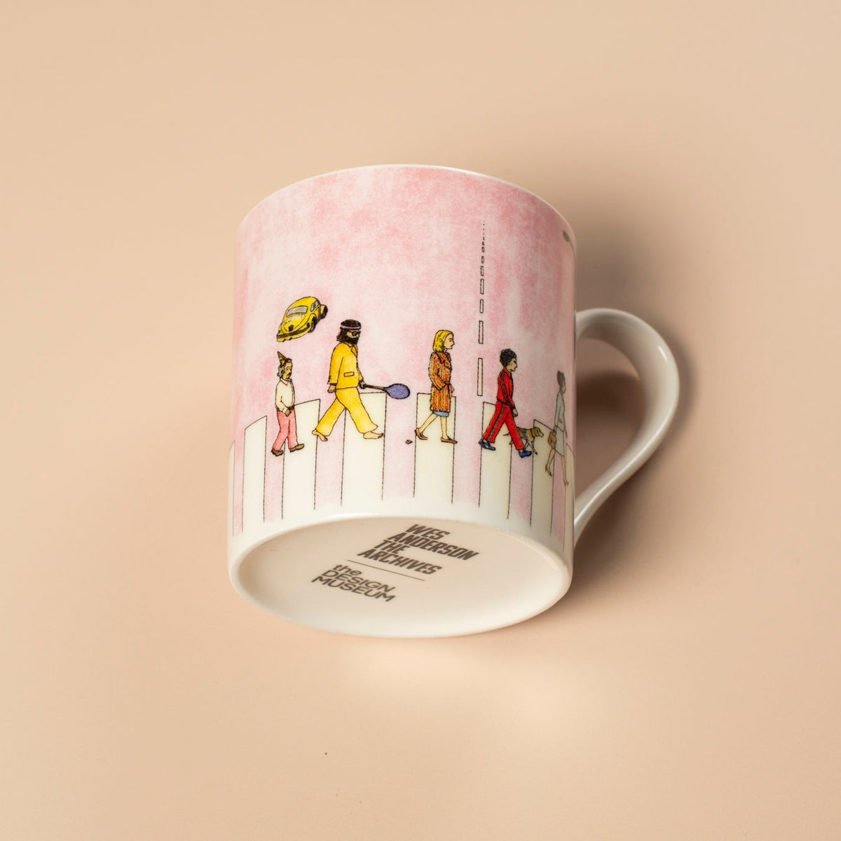 Pink mug with illustrations of people on a beige background