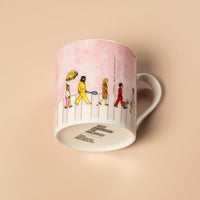Pink mug with illustrations of people on a beige background
