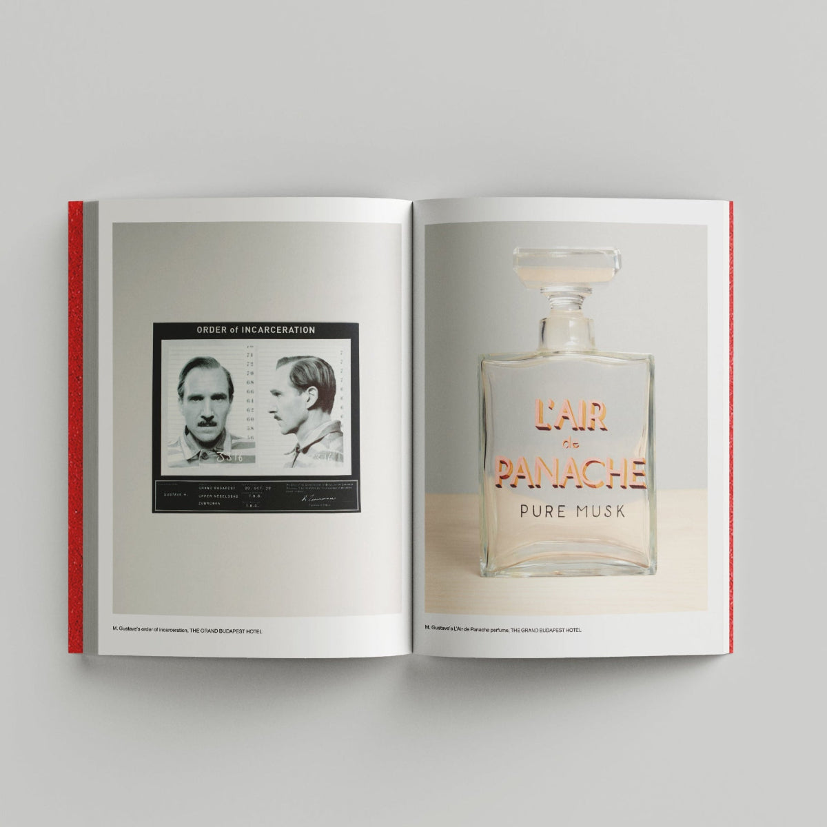 Open page of Wes Anderson catalogue displaying a perfume bottle and mugshot-style portrait on a gray background.