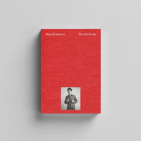 Red book titled 'Wes Anderson The Archives' with a smaller photo of a person on a gray background